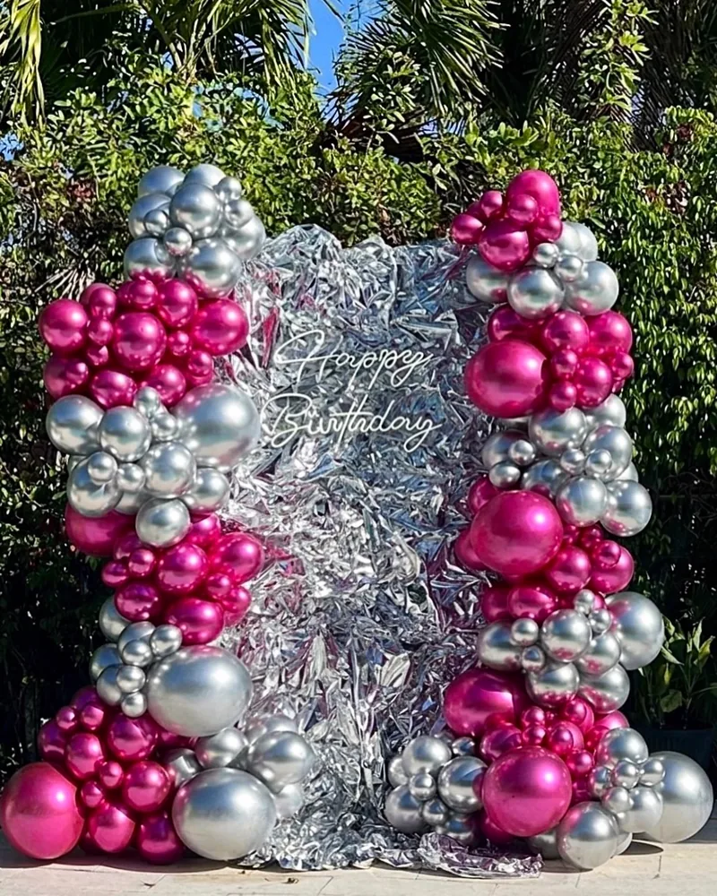 Chrome pink and silver balloon arch with a Happy Birthday neon sign