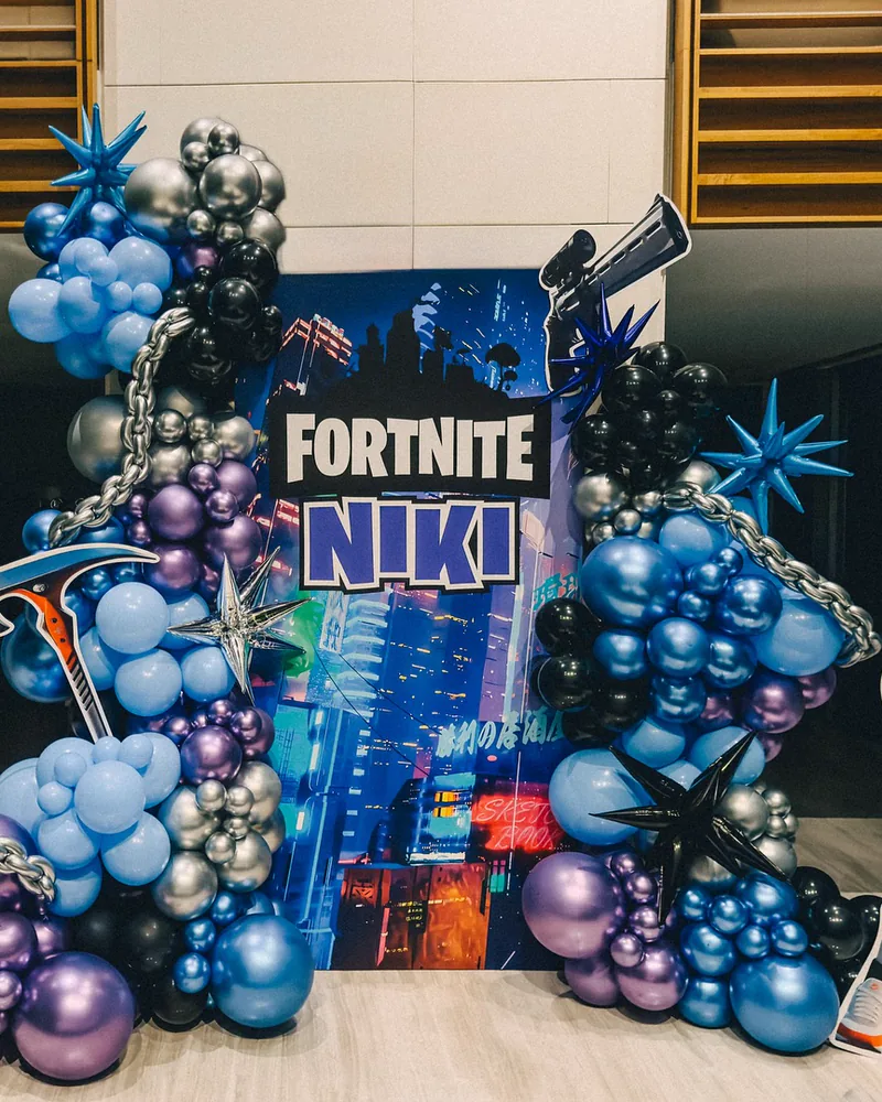 Gaming themed birthday with a custom printed backdrop and chrome balloon garland