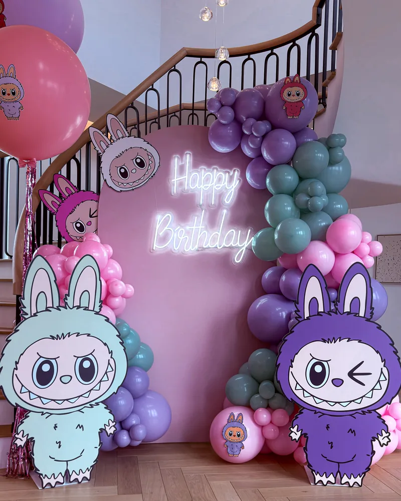 Pastel character themed birthday backdrop with a Happy Birthday neon sign