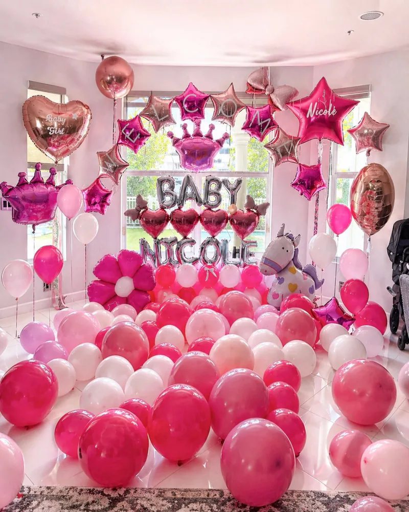 Pink room takeover for a newborn with foil name letters and crowns